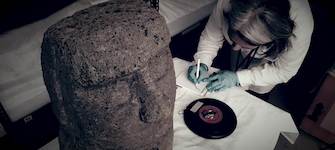 Detalle de diadema Pascuense de plumas blancas y adornos carmín.